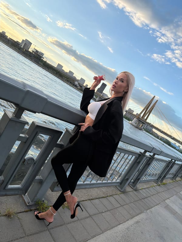Woman poses for photo by waterfront in Kazan