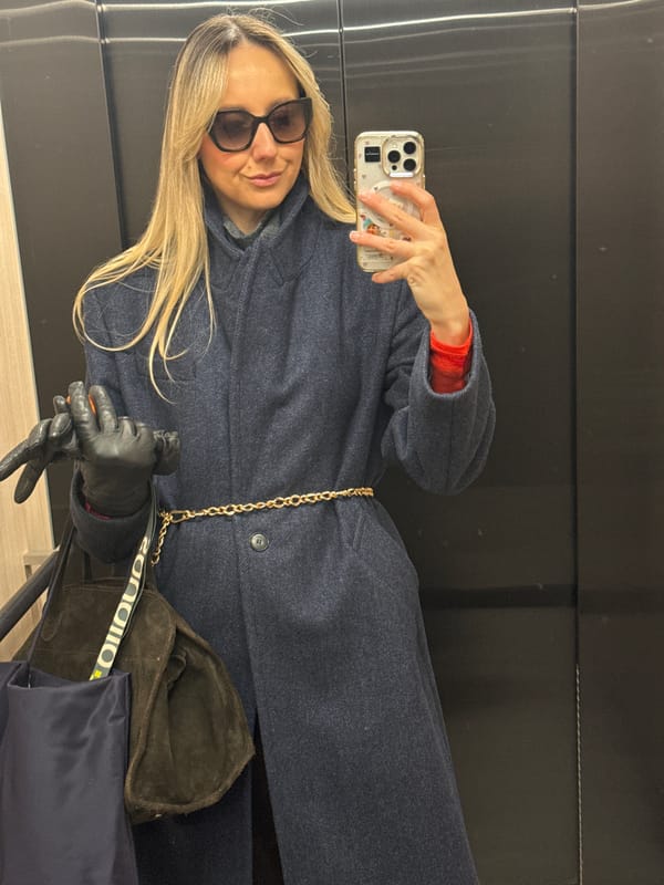 Woman takes morning selfie in reflective surface in Riga