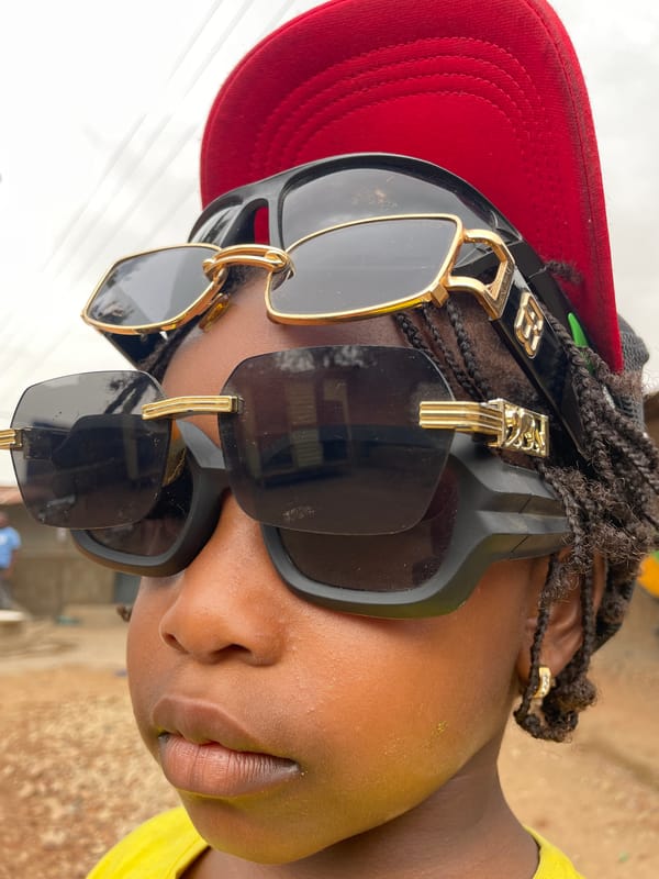 Street scenes captured in Jos show locals with phones, caps