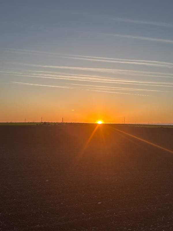 Split-sky sunset captured in Bulgarian village with contrails