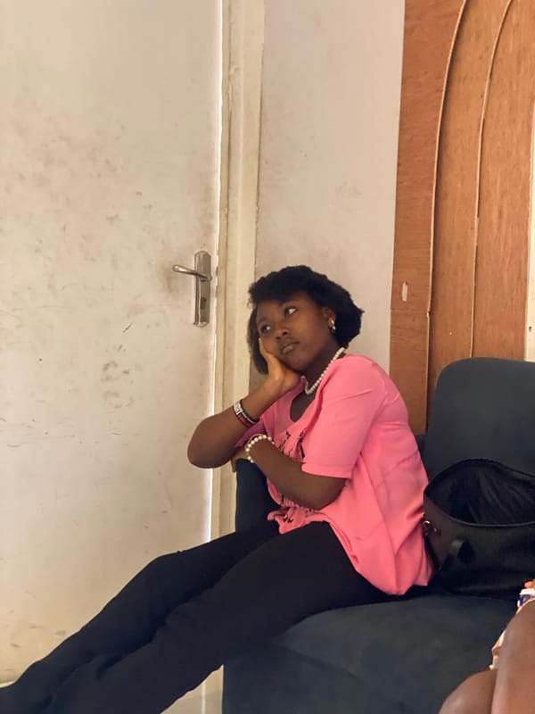 Young adults gather indoors during quiet moments in Badagry