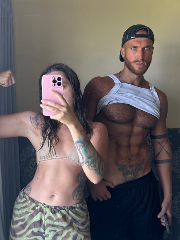 Bedroom mirror selfie session with travel luggage present