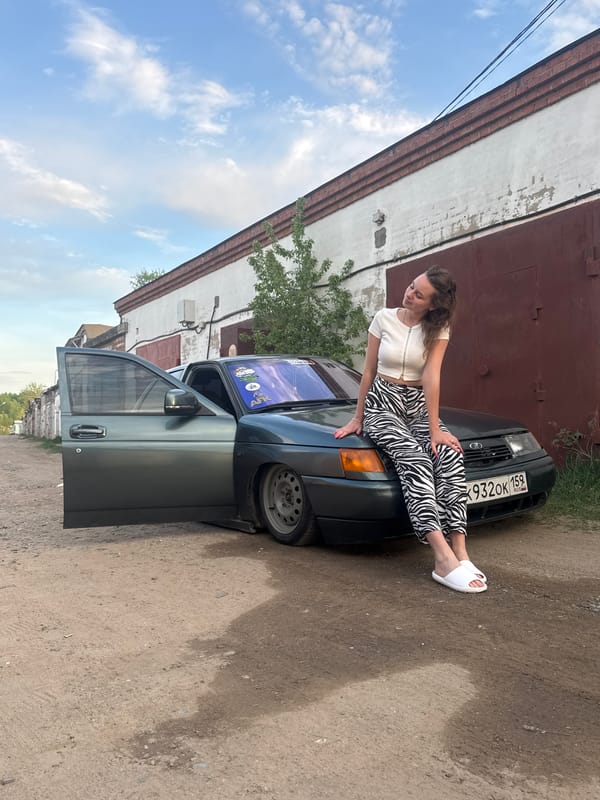 Woman poses on car during photoshoot in Chaikovsky, Russia