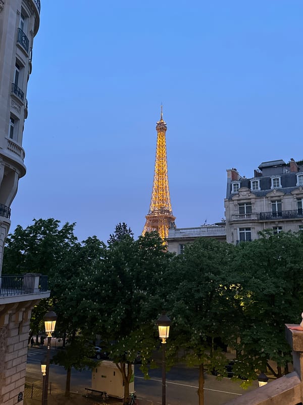Eiffel Tower illuminated at dusk in Paris