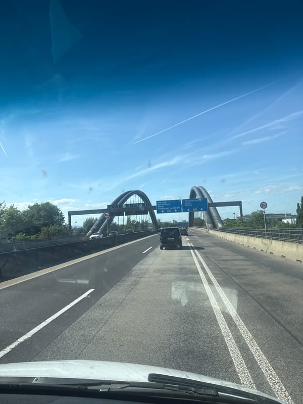 Vehicle crosses Nidda Bridge on Frankfurt autobahn during afternoon drive