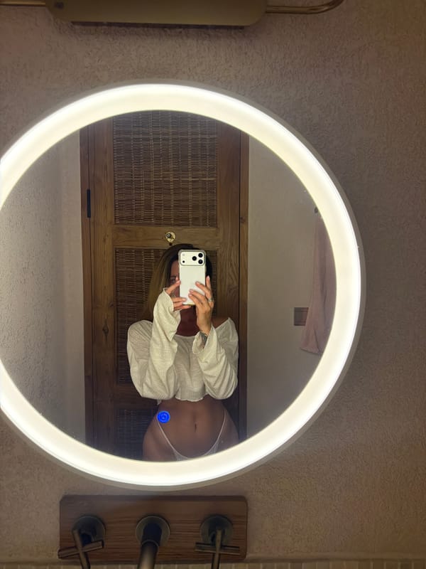 Woman takes bathroom mirror selfies in Mengwi, Indonesia