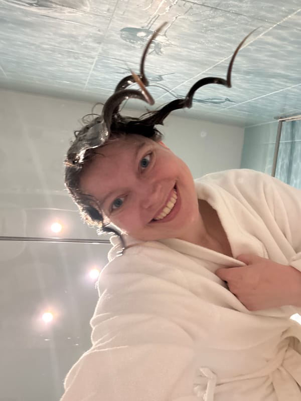 Morning beauty routine documented in Izhevsk bathroom with cat