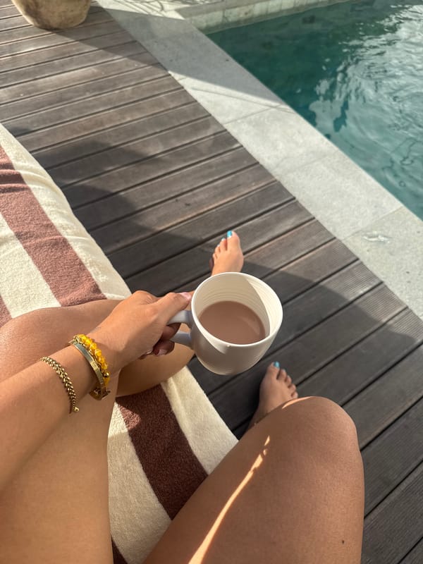 Coffee and flowers by a turquoise pool in North Kuta