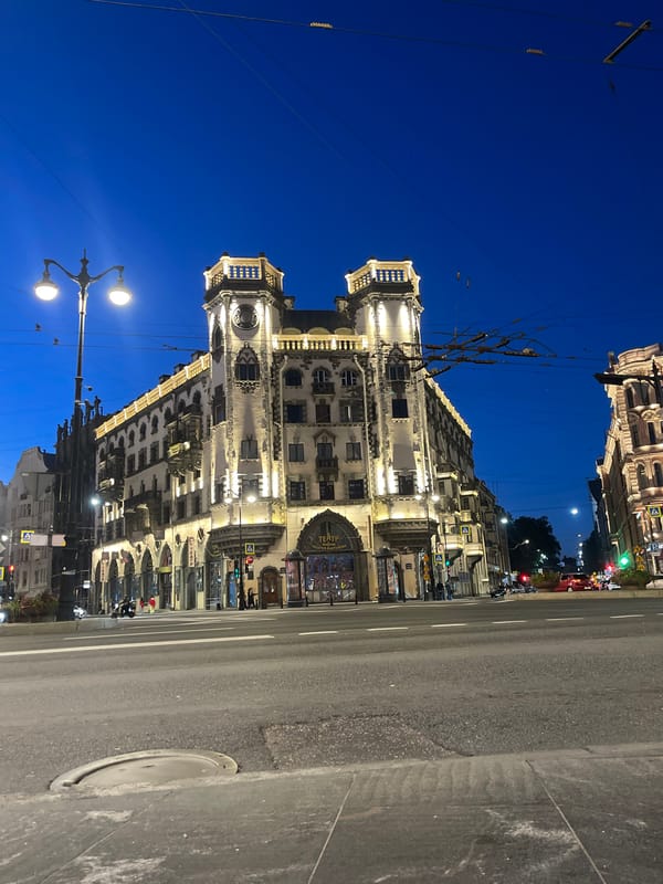 Ornate illuminated building glows at dusk in Saint Petersburg