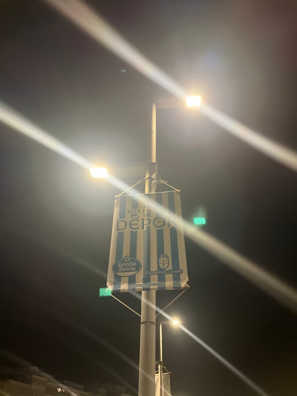 Deportivo banners illuminate A Coruña marina during nighttime stroll