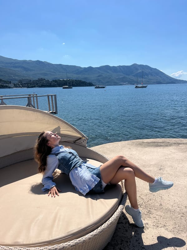 Woman enjoys morning moments at Budva waterfront pier