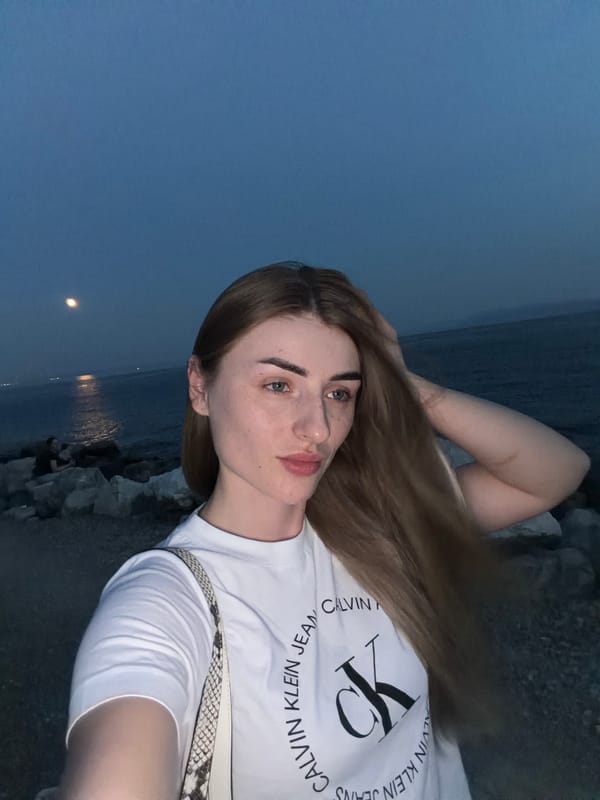 Selfies on a rocky shore at dusk, full moon rising