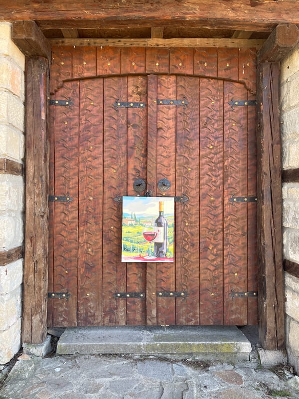 Wine painting documented on historic building door in Kiten