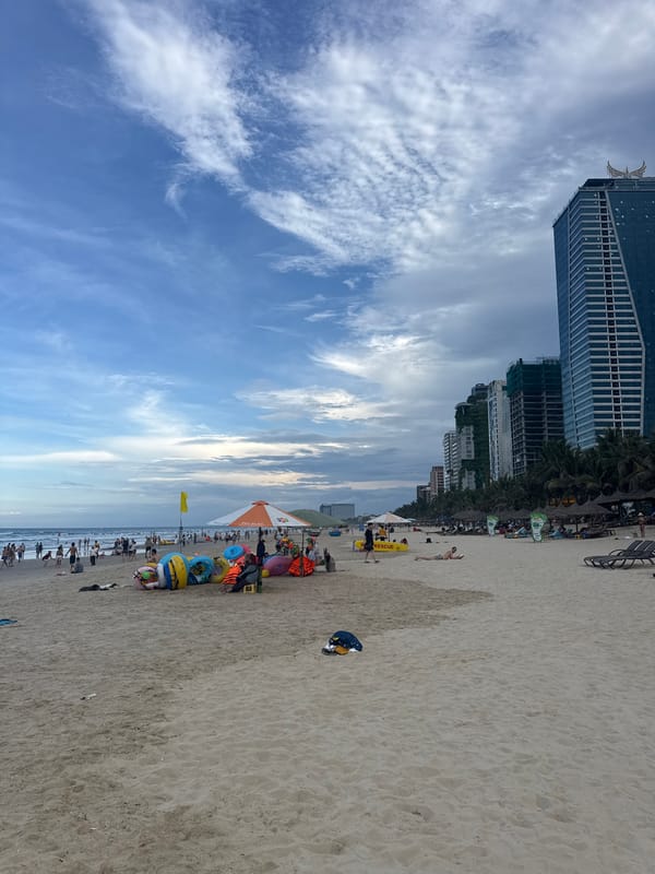 Urban beach bustling with visitors under dramatic stormy skies