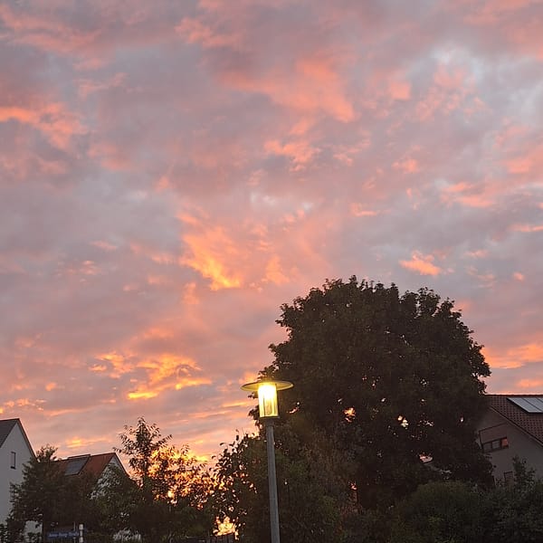 Sunset sky over apartment buildings, caught across four minutes