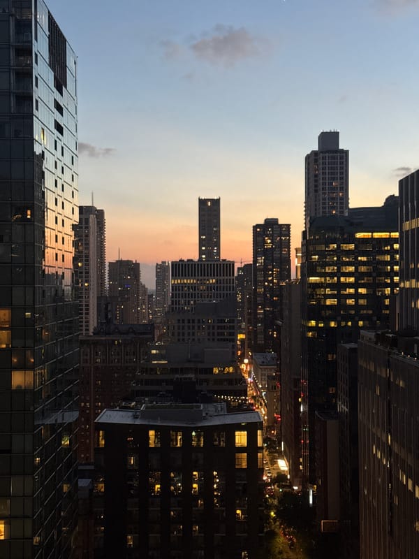 Chicago skyline at dusk, rooftop pool and city lights