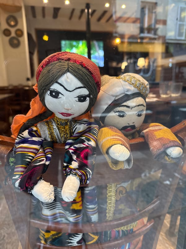 Traditional dolls displayed behind glass in Paris showcase
