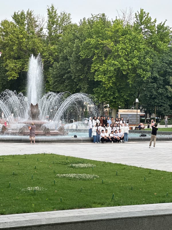 Group of 30 young adults pose for photo near Tashkent fountain