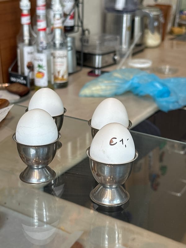 Inside a quirky Amsterdam café with pastries and eclectic shelf decor