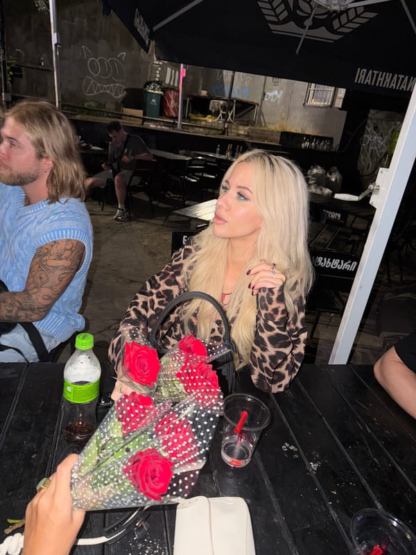 Late-night drinks and red roses at a Tbilisi outdoor cafe