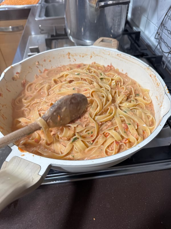 Man cooks pasta dinner at home in Aprilia, Italy