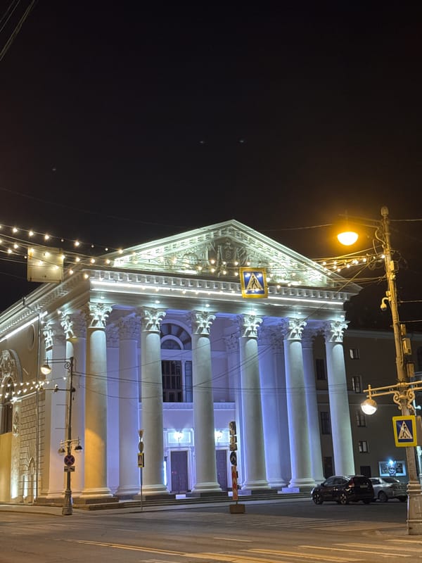 Illuminated classical building observed in evening Tver streetscape