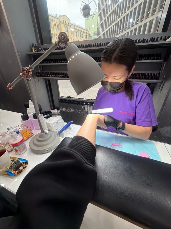 Nail technician provides manicure services in Khimki, Russia