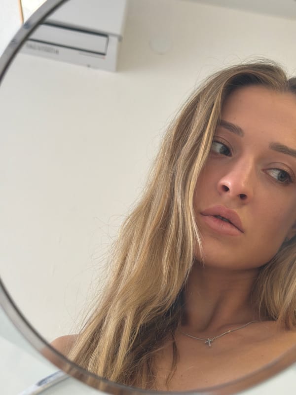 Woman gazing upward captured in mirror reflection in Khimki