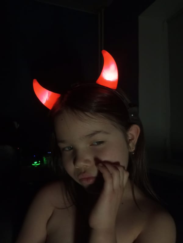 Girl in devil horns photographed with candles in Russia