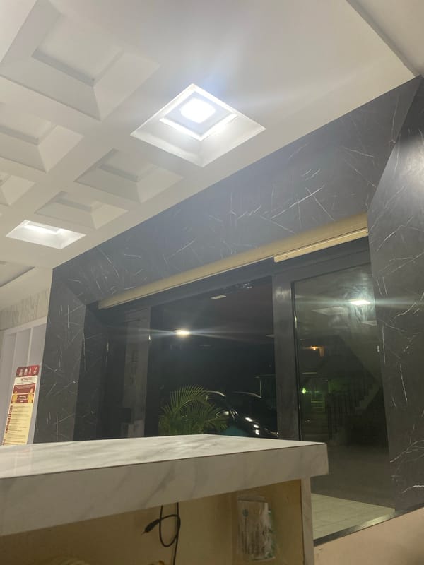 Modern marble lobby interior with coffered ceiling and recessed lighting