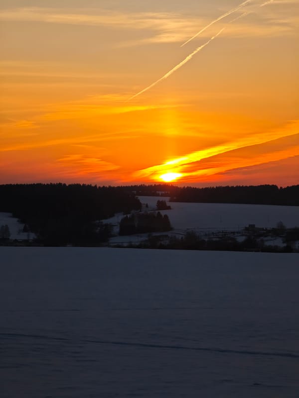 Winter sunset illuminates sky over Большая Уса, Russia