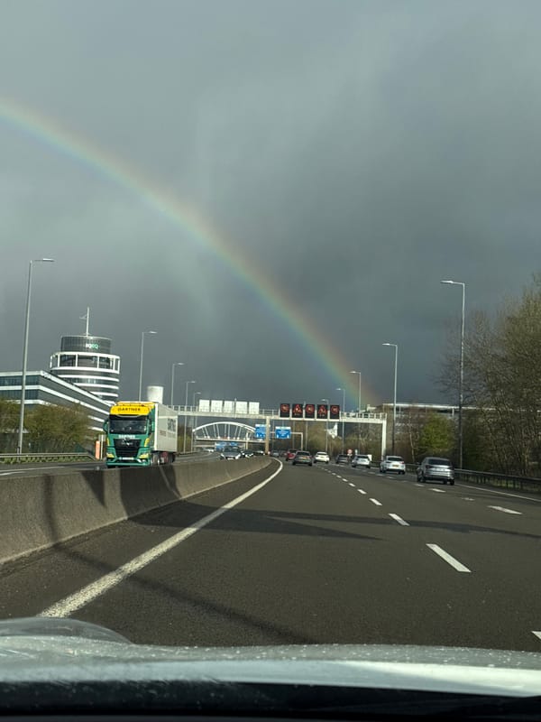 Rainbow spans sky above Luxembourg highway