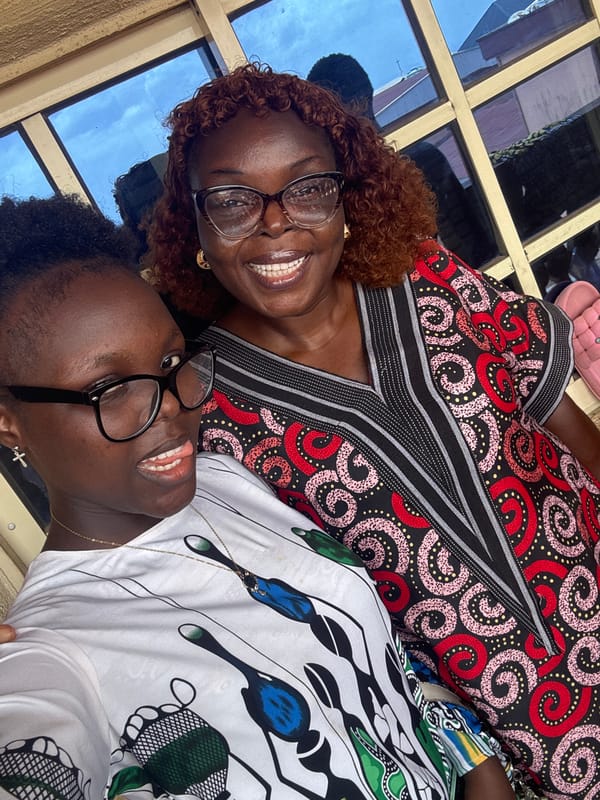 Women pose for photos in colorful Sunday attire in Onitsha