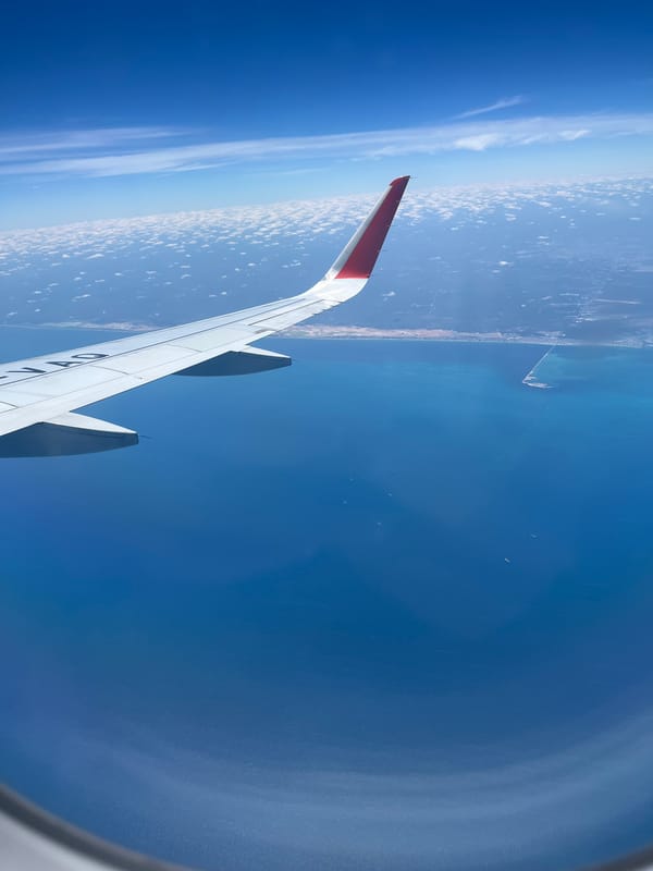 Passenger documents aerial views of Cancún coastline from aircraft