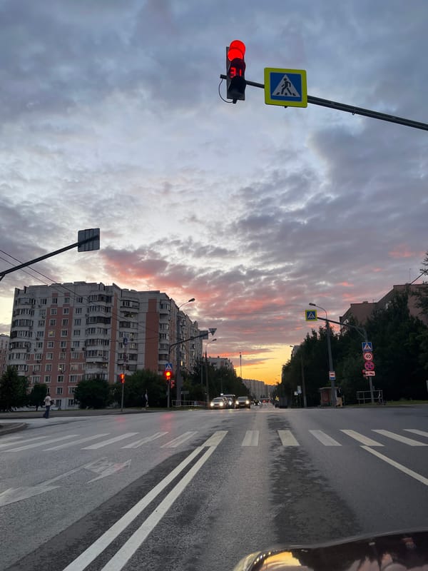 Moscow intersection glows under a dramatic June sunset sky