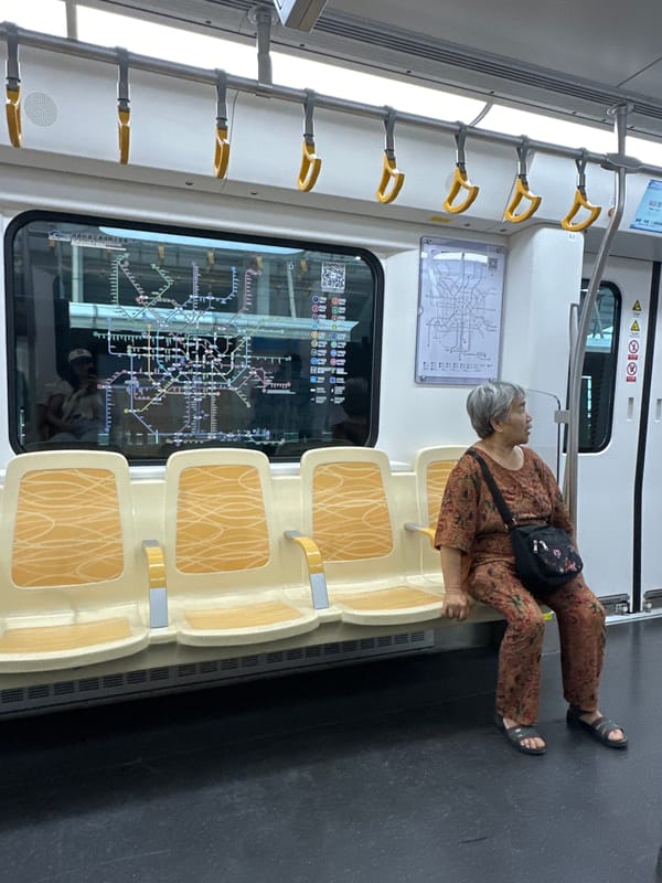 Elderly passenger stretches across empty train seats in Jianyang
