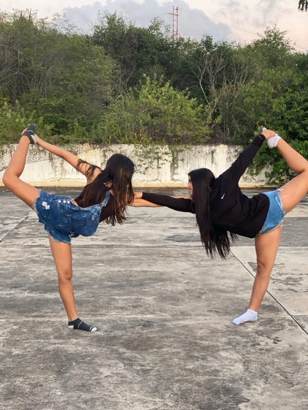 Young adults perform acrobatics during sunset in Juan Griego