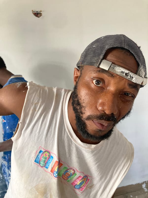 Paint worker observed with smartphone in Bukuru, Nigeria