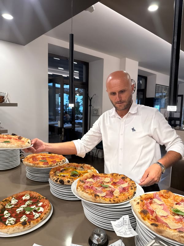 Neapolitan pizzas being prepped at a Trento pizzeria