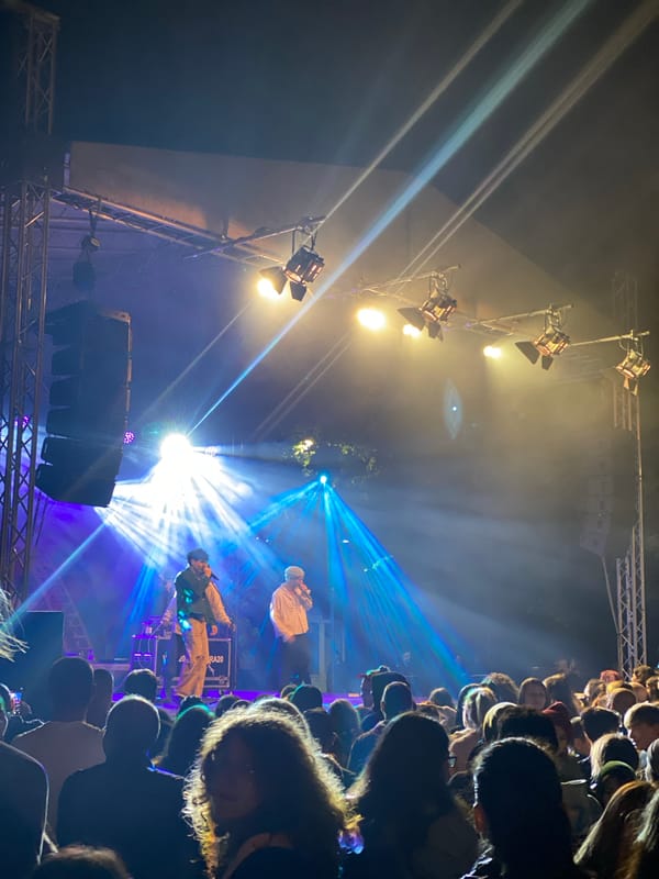 Nighttime concert draws crowd with colored stage lighting
