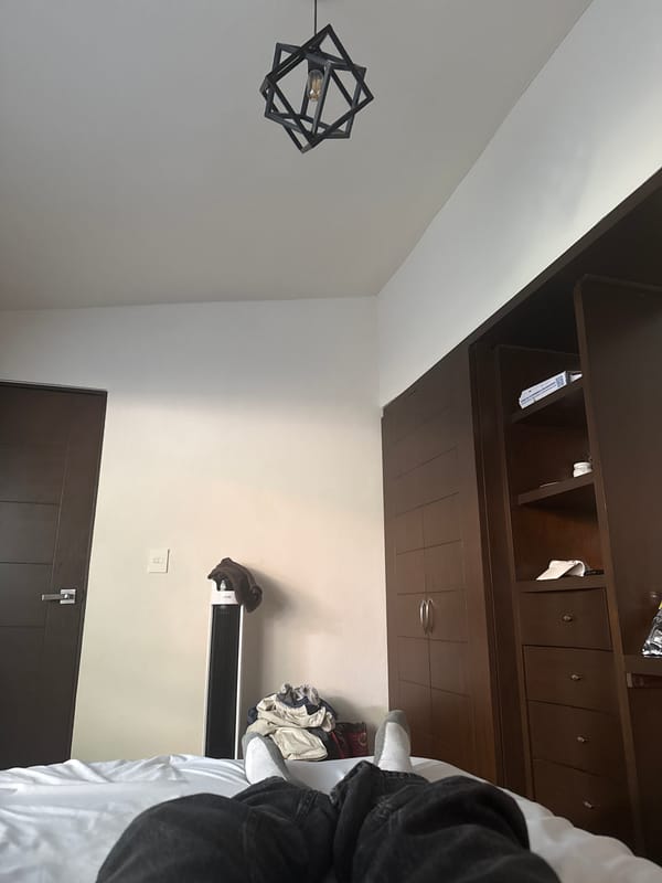 Bedroom scene with wooden wardrobe documented in Puebla