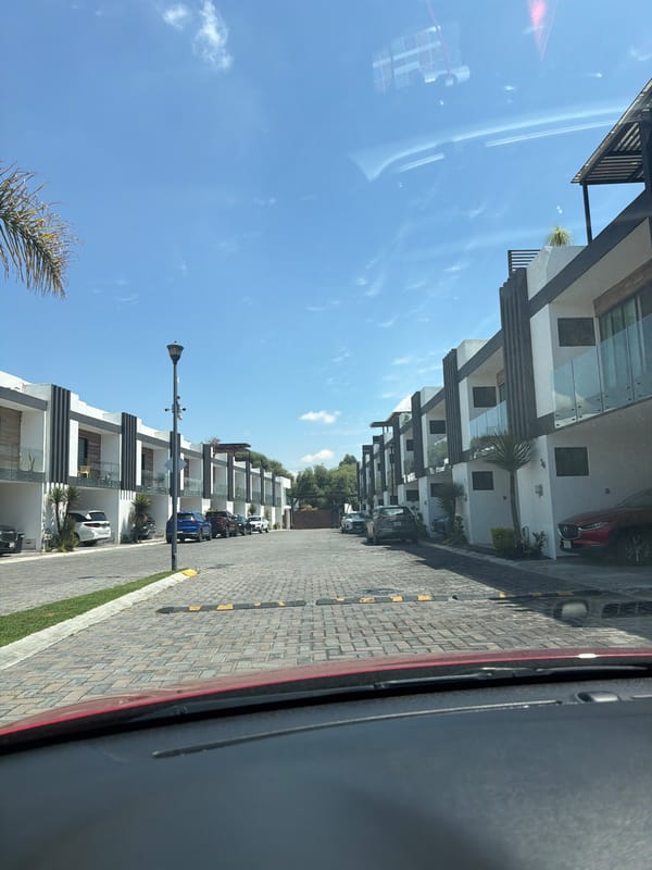 Modern townhouses line residential street in Cholula, Mexico