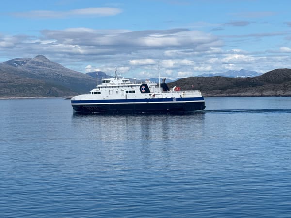 Multi-deck ferry crossing calm Norwegian waters