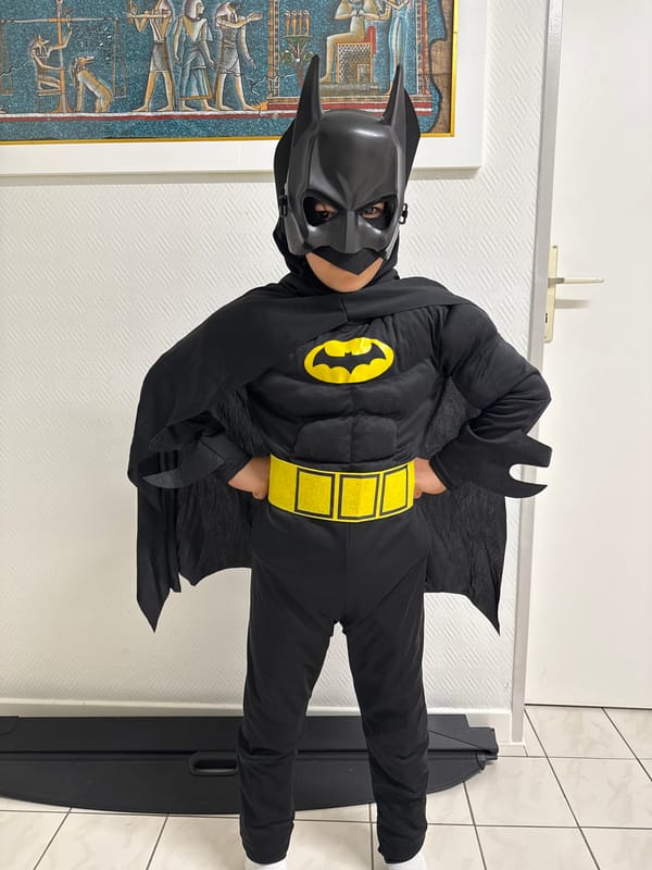 Child in Batman costume spotted indoors in Pétange, Luxembourg