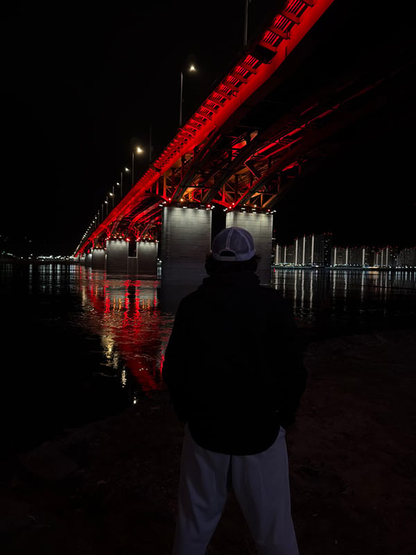 Person observed near illuminated Krasnoyarsk riverbank at dusk