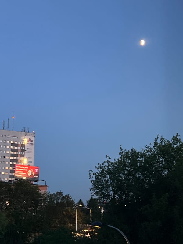 Crescent moon over Warsaw on a June evening