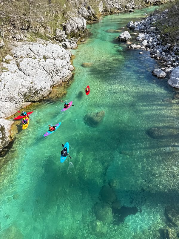Kayakers navigate Soča River waters near Kobarid, Slovenia