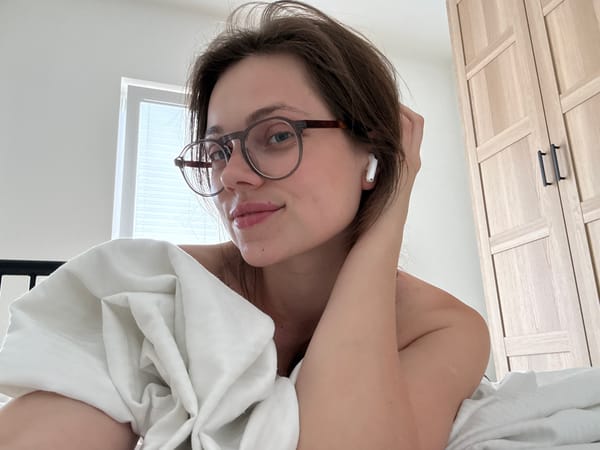 Chilling in bed with earbuds in, mid-afternoon