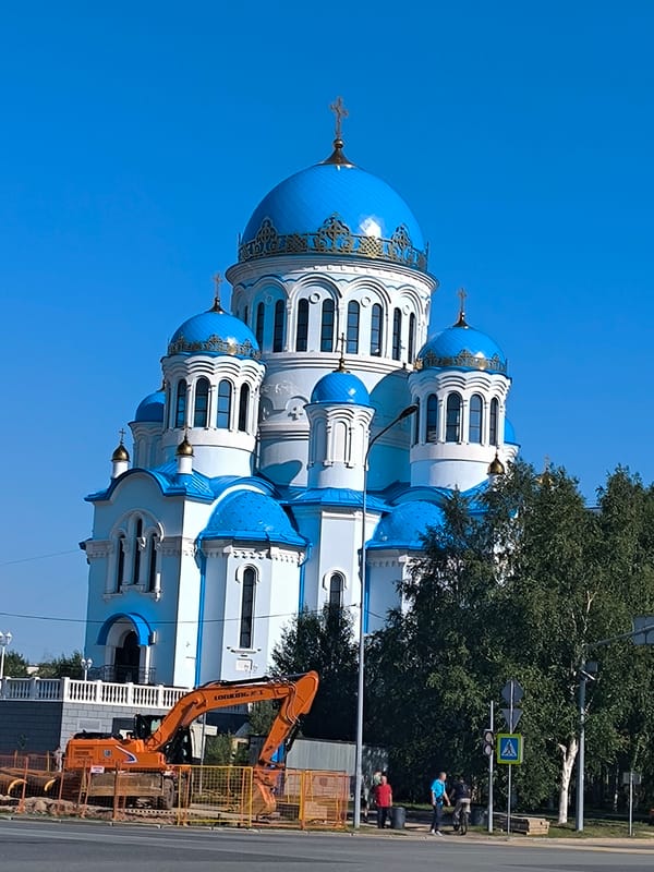Orthodox church gleams under blue skies in Surgut, Siberia