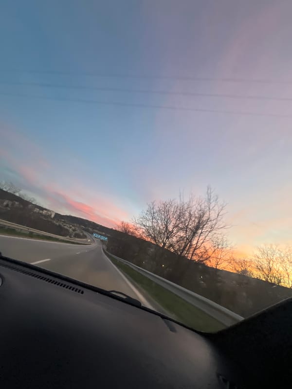 Vehicle travels curved highway near Lovech during sunset